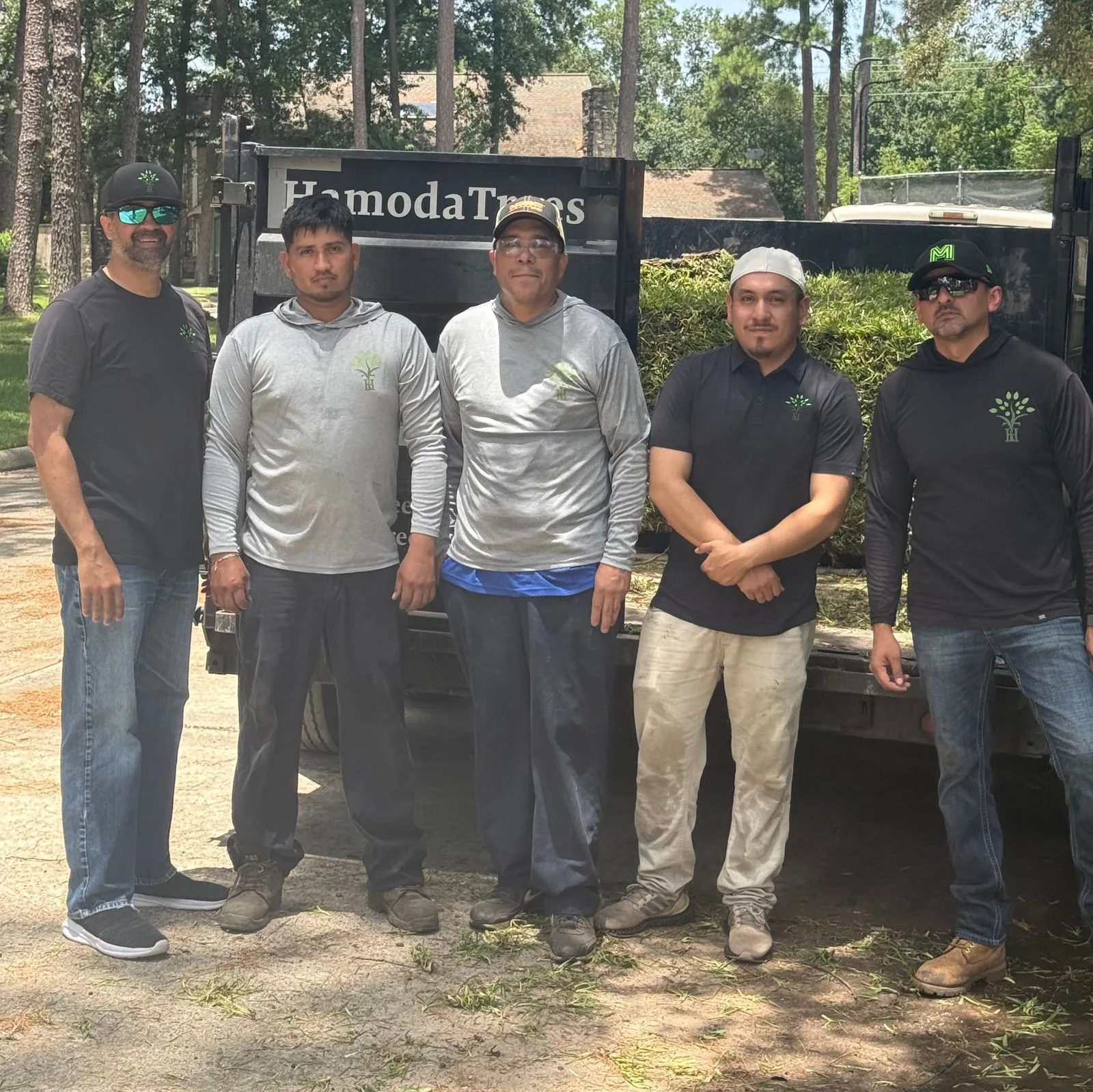 The full HamodaTrees crew in front of a company trailer loaded with sod in Houston, TX