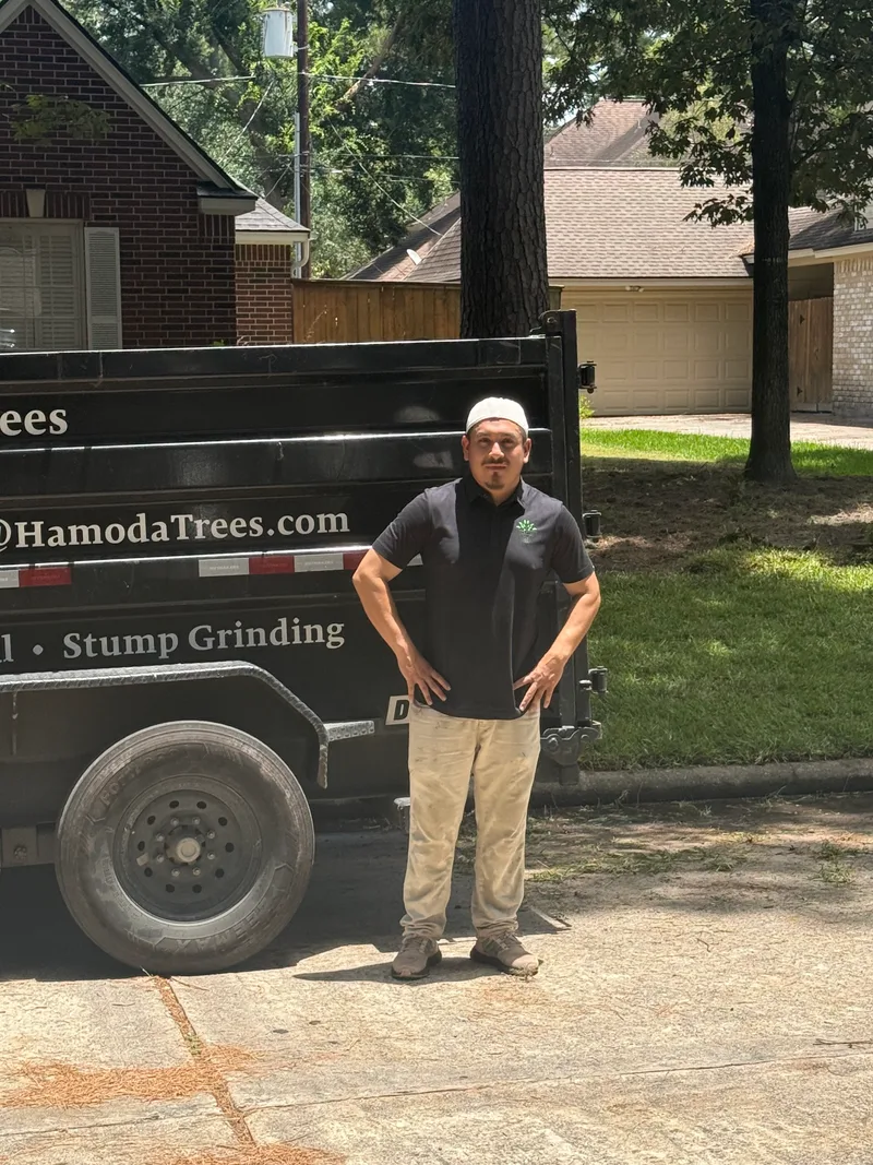 Ramiro, HamodaTrees crew supervisor, standing by the company trailer in Houston, TX